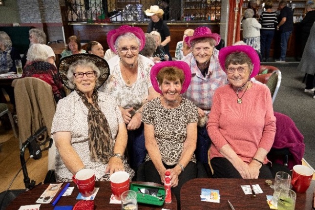 Ladies wearing a purple cowboy hat