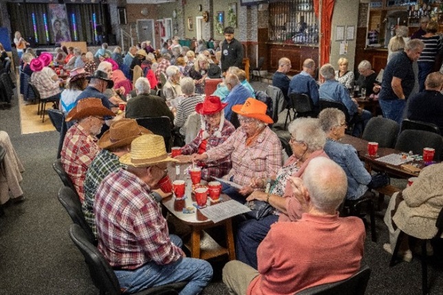 People sitting at tables in a hall